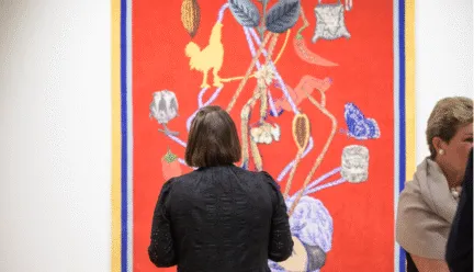 woman in museum looking at artwork